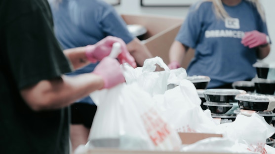 Volunteers helping to pack supplies in bag