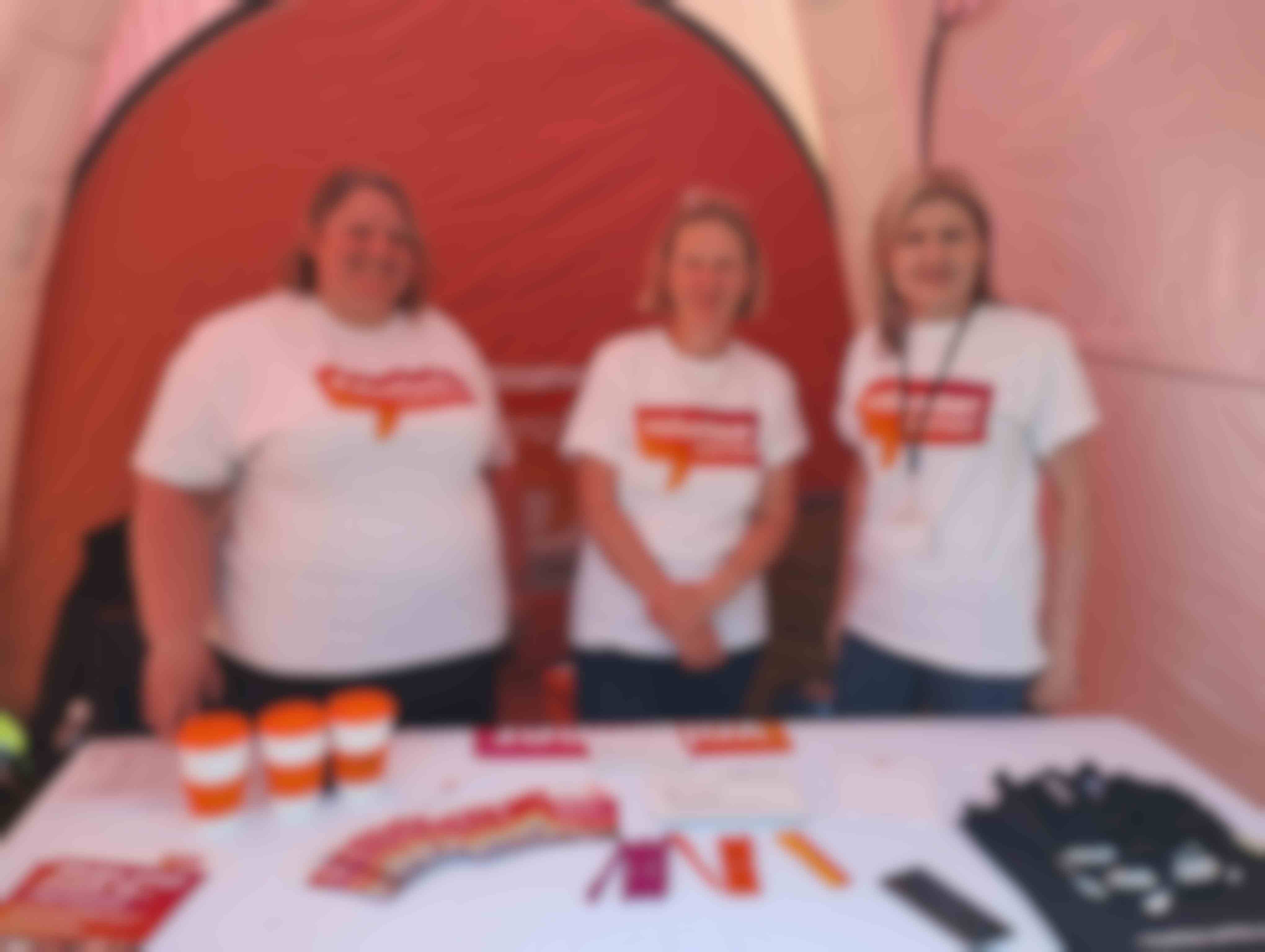 Two people wearing Volunteer Cambs t shirts