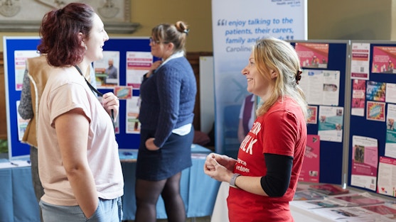 A Voluntary Norfolk staff member chats to a member of the public in a community space