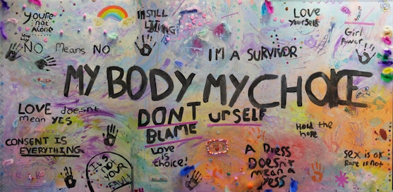 A colourful wall with graffiti all over it. the main text reads 'my body my choice'