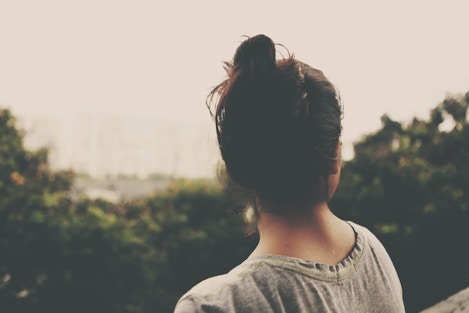 Photo of woman looking away from camera and into distance
